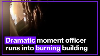 Watch dramatic moment police officer runs into burning building to save families
