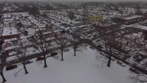 Soar over a snow-covered New York neighborhood