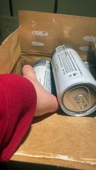 Case With Two Empty Cans