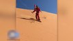 Guy Dressed As Santa Does Snowboarding In Sahara Desert Sand Dunes