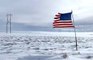 American Flag Blowing in Freezing Landscape