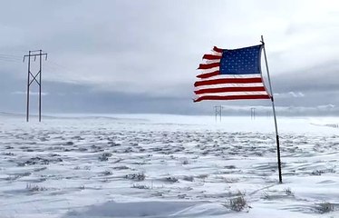 American Flag Blowing in Freezing Landscape
