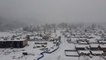 Fly over a snow-coated Washington neighborhood