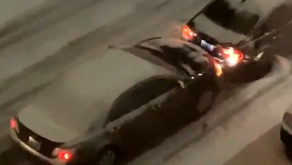 Car struggles to push another car up a hill in Seattle