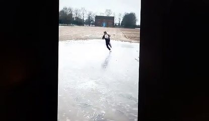 Girl missing ice skating finds a frozen puddle to practice on