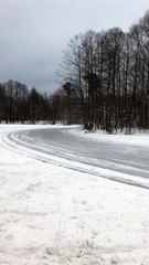 Group of Cars Slide Around Icy Corner