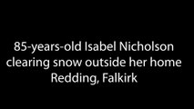 85-years-old Isabel Nicholson clearing snow outside her home in Redding, Falkirk