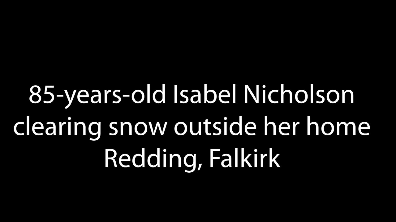 85-years-old Isabel Nicholson clearing snow outside her home in Redding, Falkirk