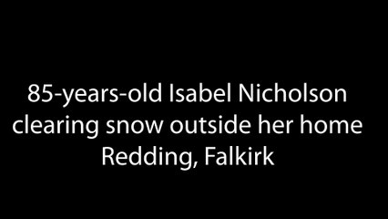 85-years-old Isabel Nicholson clearing snow outside her home in Redding, Falkirk