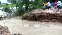 Men drag LPG cylinder on flooded street, flooding river in Pratapgarh, UP