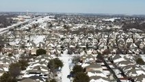 Soar over a snow-covered neighborhood in northern Texas