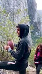 Talented Dude Catches Football while Balancing on High Slackline