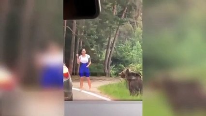 Woman poses for picture with wild bear at roadside – ends up running for her life