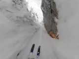 Skier Elated After Skiing Down Narrow Gully in Snowy Mountains