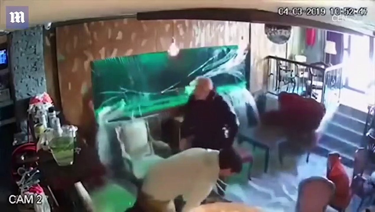 Aquarium inside cafe explodes leaving two men drenched in water