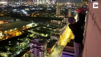 Daredevil Climber Does Chin Ups On Top Of Building