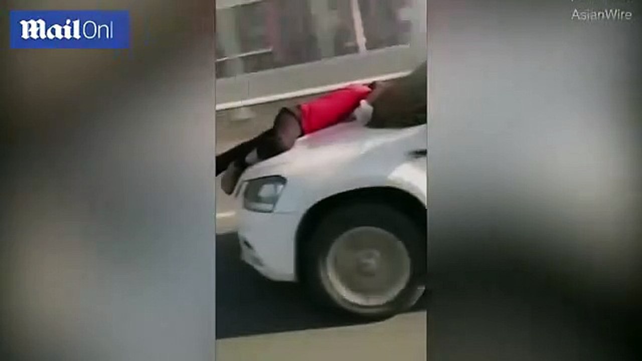 Street cleaner clings onto a womans car bonnet for eight miles after she ran over his BROOM