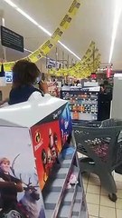 Funny, a woman is taking off her clothes in a supermarket to make a mask