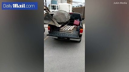 Man uses bulldozer to drop giant boulder on pickup truck - Daily Mail