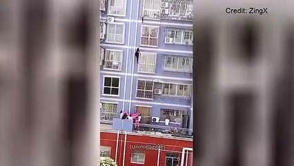 Man scales a building to save a baby dangling from a window