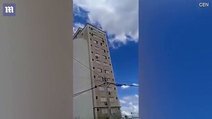 The shocking moment child balances on 7th-floor window ledge
