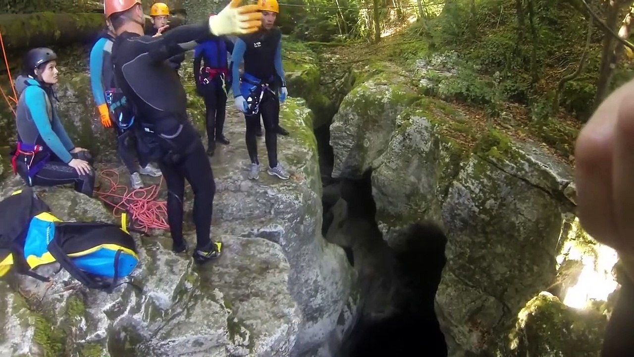 A man falls into water in a canyon