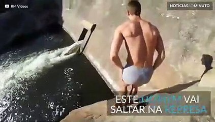 Homem salta em paredão de represa e volta. Impressionante!