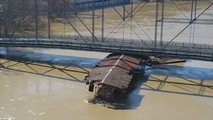 Flooding causes loose marina to slam into bridge
