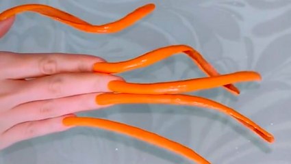 See how a woman with multiple records for the longest nails in Russia cooks, cleans, and protects her nails