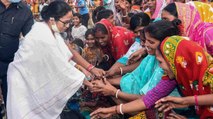 Mamata distributes prasada among women after worship