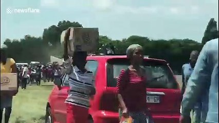Looters in South Africa steal crashed lorrys washing powder