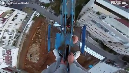 This kid scaled a crane and hung off it!