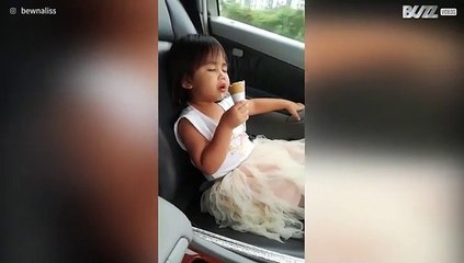 Girl struggles against sleep to eat ice cream