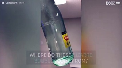 Sparkling water inside bottle bubbles behave weirdly