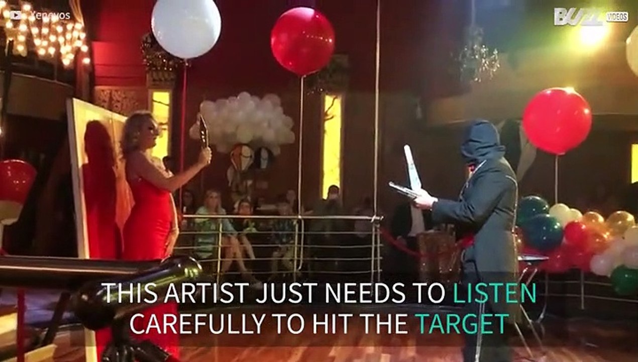 Blindfolded artist throws knives