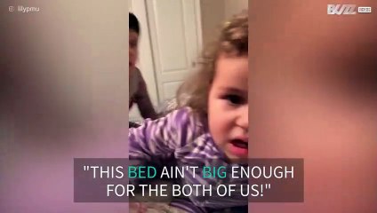 Little girl pushes brother off of bed