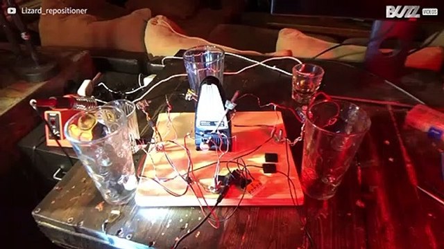 Guy makes music using metronome and glasses of water