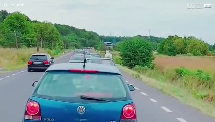 Driver walks a horse on busy road