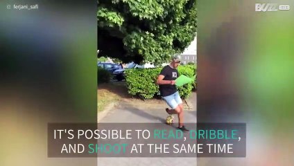 Footballer shows off fancy footwork and hits the target... while reading!