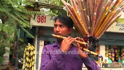 Bamboo flute player in a busy market