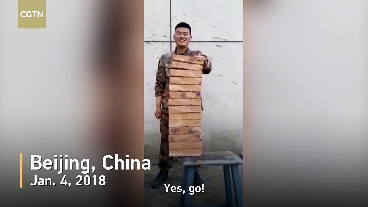 Military officer breaks 14 bricks using his hand