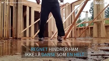 Regnet ødelegger ikke dansefesten til denne byggearbeideren