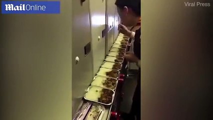 Air stewardess caught on camera eating passenger MEALS