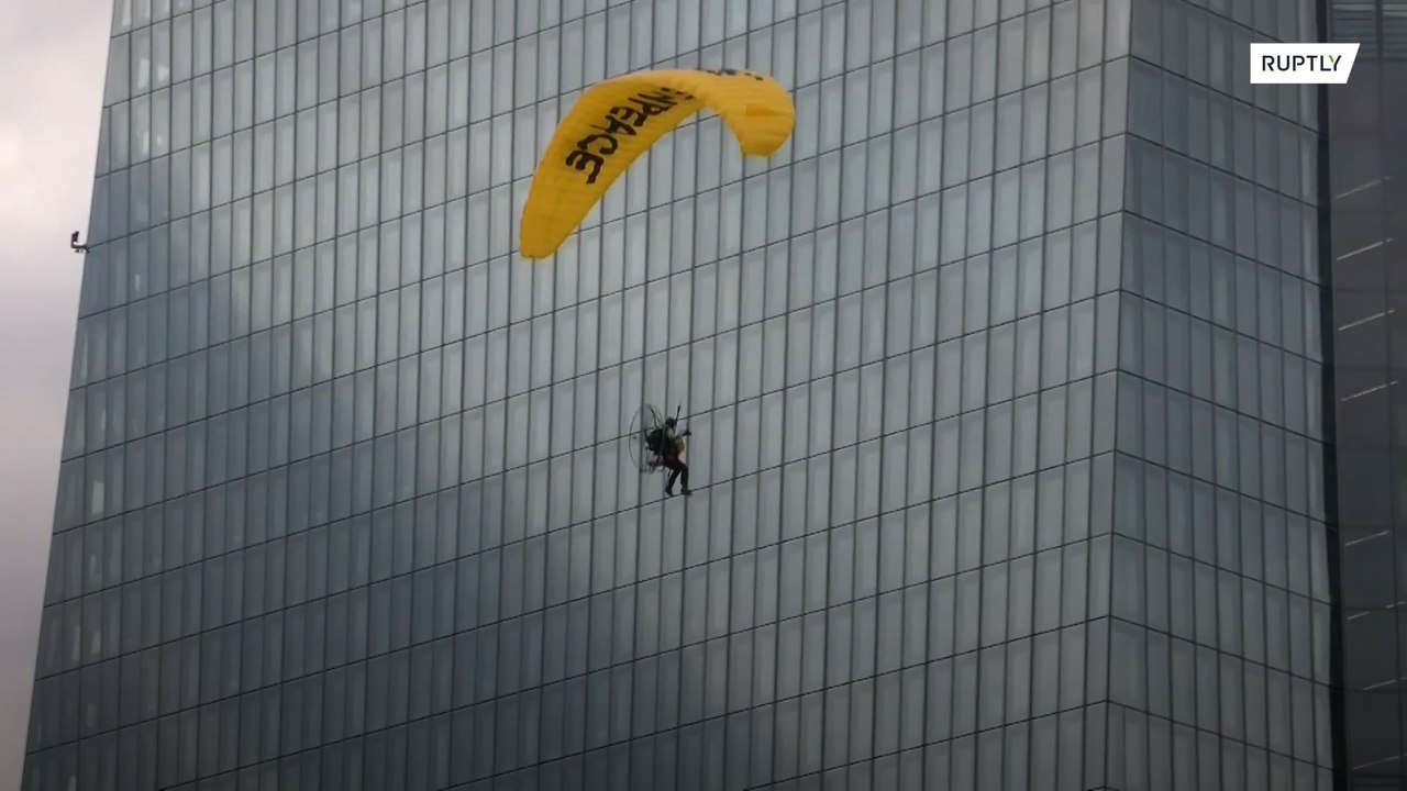 Greenpeace activists on paragliders land on ECB building in climate protest