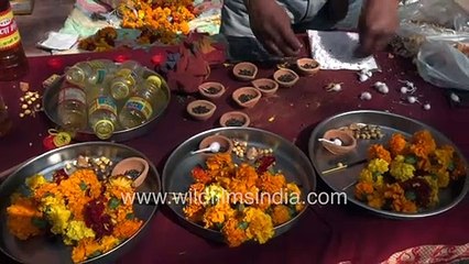 Hindu devotees indulge in buying offerings of mustard oil, marigolds, earthen lamps outside temple