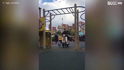 Jovem faz barra com uma scooter presa no corpo