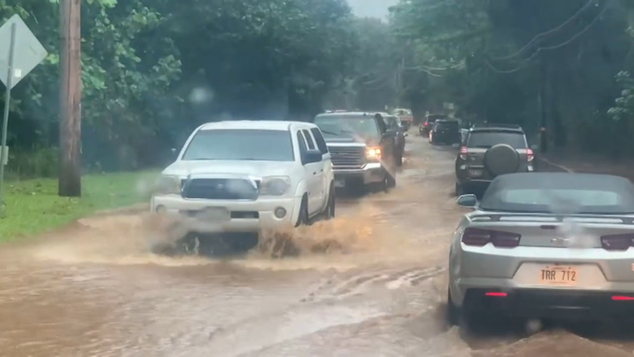 Cars drive through flooded streets in Hawaii