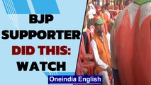 BJP supporter paints lotus symbol on the body ahead of PM Modi's visit | OneIndia News