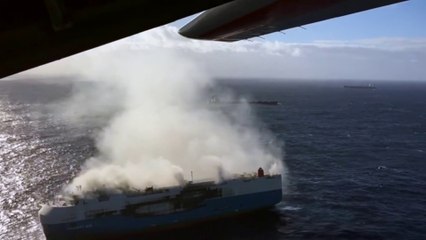US Coast Guard Hercules flies over Burning Ship