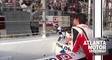 Ryan Blaney hands checkered flag to a young fan after his Atlanta win